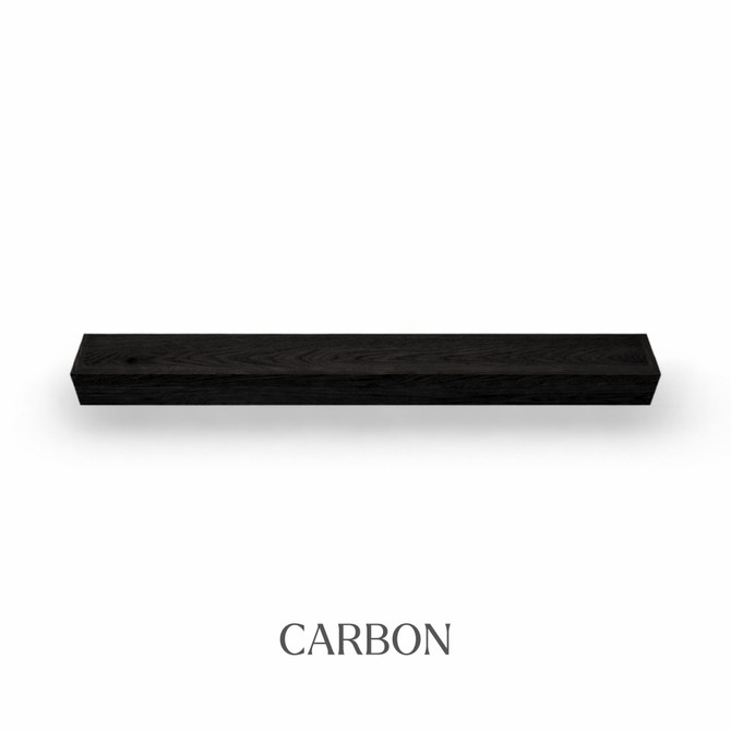 Top view of a 5-inch thick red oak floating mantel finished in carbon, showing near-black tones with visible wood grain.