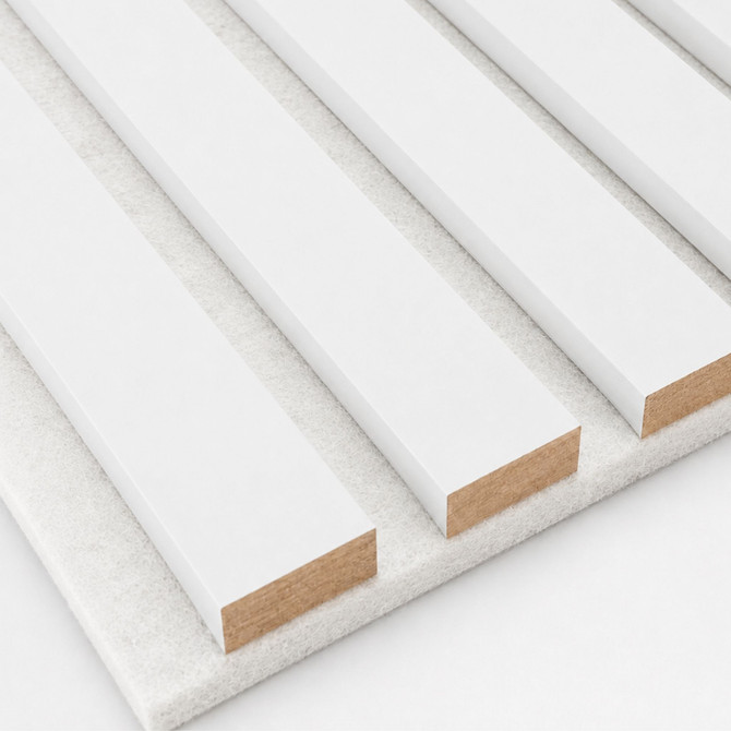 Close-up of white painted slat wall panel showing the smooth white finish, 1-inch slats, and light textured acoustic felt backing.