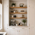 Superior alder alcove floating shelves with warm natural wood grain installed above a built-in kitchen coffee bar.