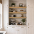 3-inch White Oak alcove floating shelves installed in a built-in kitchen coffee bar with white cabinetry.