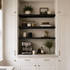 2-inch Painted Black Maple alcove floating shelves installed above a built-in kitchen coffee bar with white cabinetry.