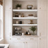 3-inch Painted White Maple alcove floating shelves installed above a built-in kitchen coffee bar with white cabinetry.