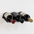 Powder-coated black wall-mounted wine rack holding three wine bottles horizontally against a light wall.