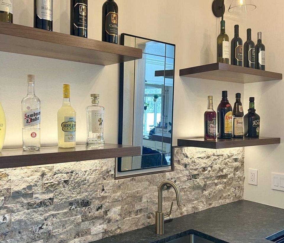 LED-lit floating shelves in wet bar kitchen area
