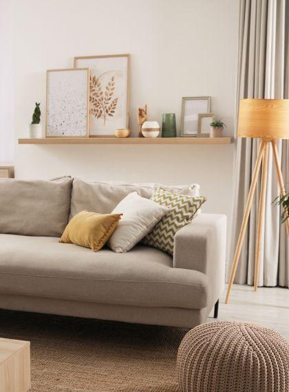 Extra Long Custom Floating Shelf Made with White OaK Behind a Sofa in Living Room