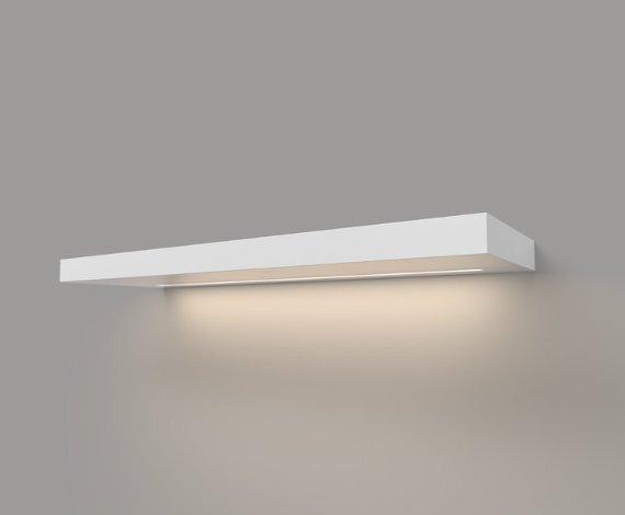 White LED lighted floating shelf, 1.625 inches thick, shown with soft down lighting against the wall