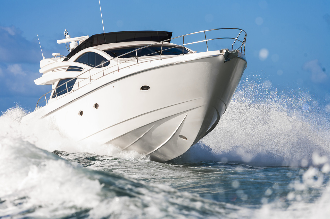 Motor boat going fast threw the water viewed from the front with water spraying and churning
