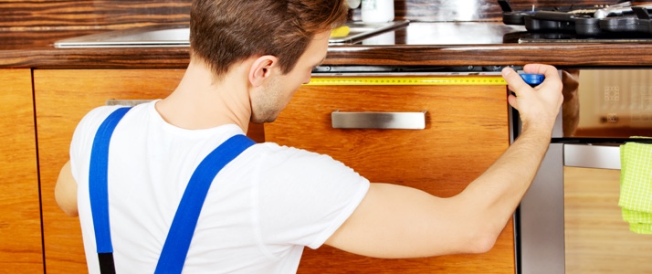 cabinet maker measuring a door