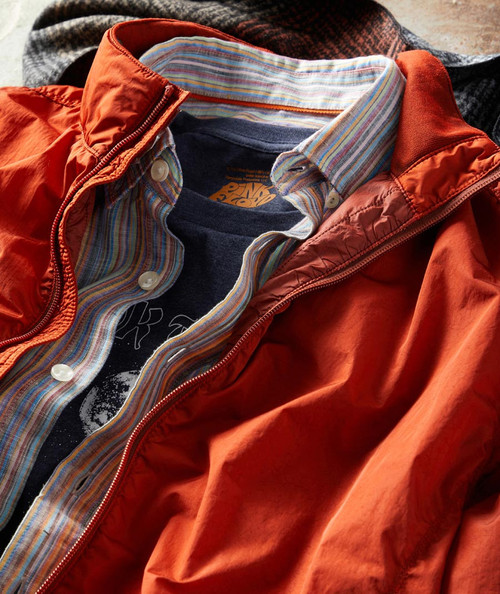 32 Bar Blues Any Way The Wind Blows, casual men's layered clothing outfit featuring an orange jacket, a striped button-up shirt, and a graphic t-shirt