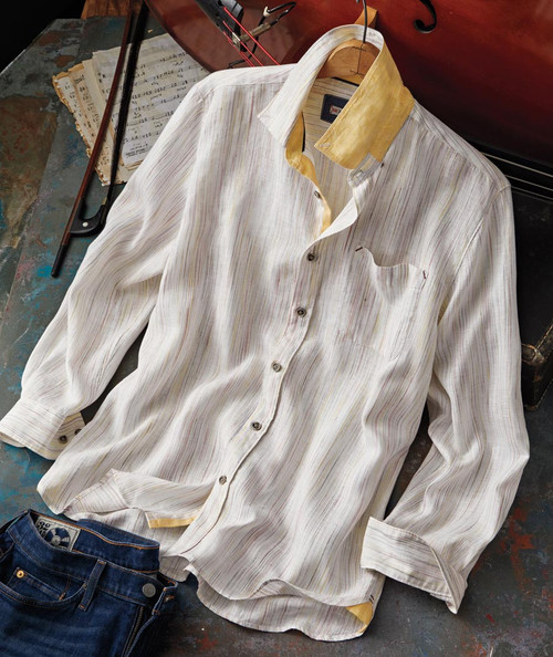 32 Bar Blues Smile At Me, a white button-up shirt with subtle multicolored stripes, displayed on a hanger next to a violin and sheet music.