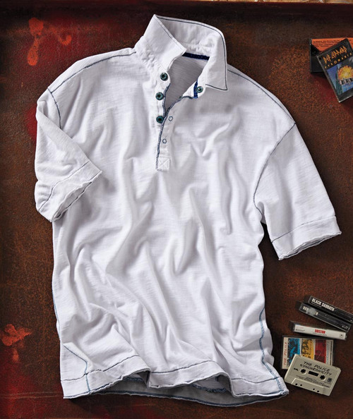 32 Bar Blues Who's Got Rhythm? white polo shirt with navy blue accents, laid flat on a surface with scattered cassette tapes and a box of CDs.