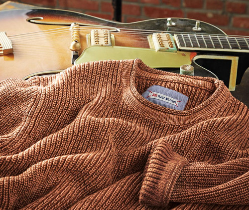 32 Bar Blues Copper Kettle, a vintage electric guitar with a sunburst finish and cream pickups, accompanied by a brown knitted sweater with a 32 Bar Blues label.