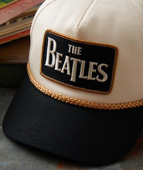 32 Bar Blues Tell It Like It Is, Beanie cap with a patch of The Beatles logo, black brim, and beige crown featuring embroidered text, stylish and musical-themed accessories.