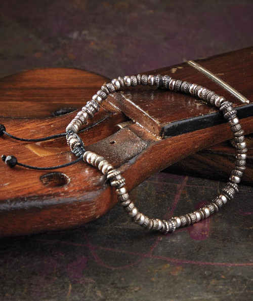32 Bar Blues Klang, beaded jewelry on a wooden surface.