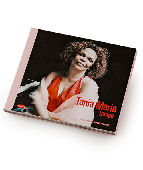 32 Bar Blues Tania Maria - Tempo CD, album cover featuring artist Tania Maria smiling with curly hair, wearing an orange top, and sitting next to a piano.