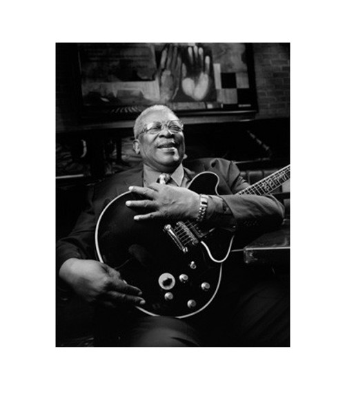 32 Bar Blues Jimmy Katz - BB King Print, black and white photo of BB King smiling while holding an electric guitar in a cozy, artistic setting.
