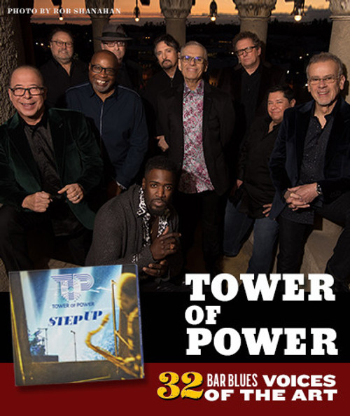 32 Bar Blues Tower Of Power - Step Up, a group of nine musicians posing outdoors during sunset with an ancient architectural background, holding their instruments and smiling.
