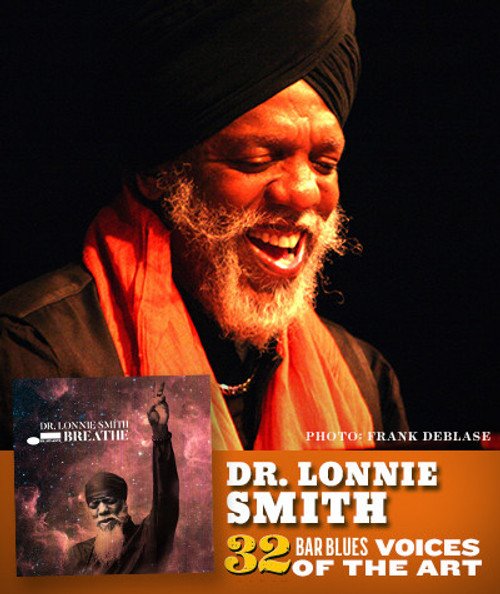 32 Bar Blues Dr. Lonnie Smith - Breathe, close-up of Dr. Lonnie Smith performing with a joyful expression, wearing a black turban and red scarf, with album cover and text overlay in the image.