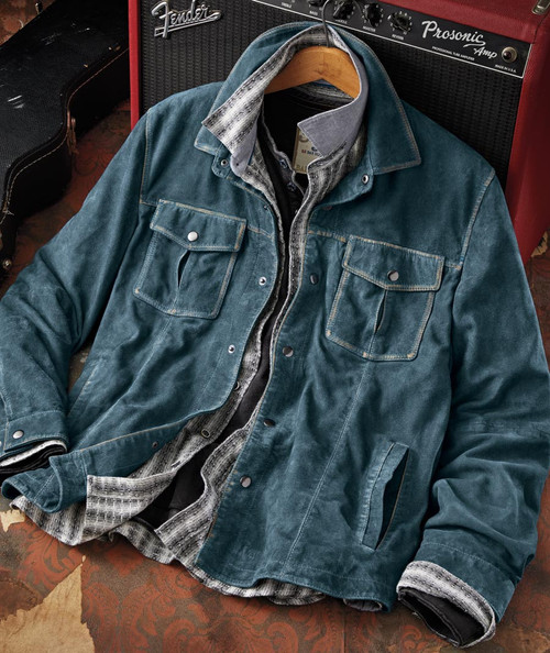Product 32 Bar Blues Just Like That, denim and plaid layered jackets on a hanger, placed on a vintage rug with a Fender amplifier in the background.