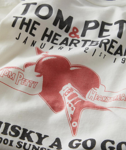 32 Bar Blues Between Two Worlds T-shirt, close-up of the graphic design on a white fabric featuring red and black text and imagery.