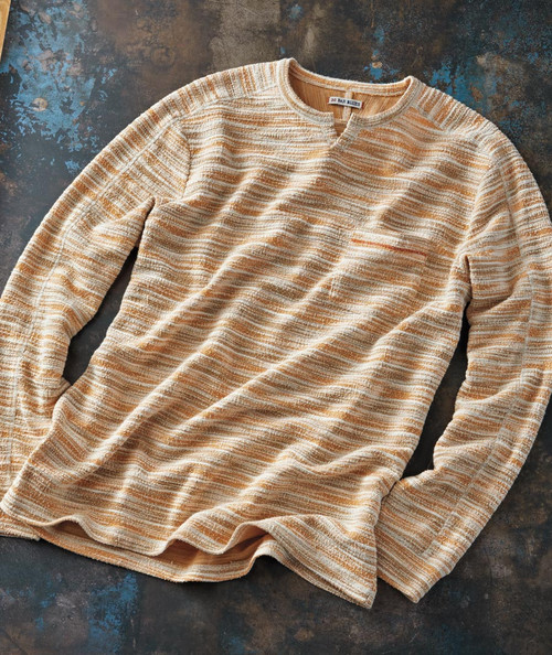 32 Bar Blues Zooma Zooma, striped beige and brown knitted sweater laid flat on a dark textured surface.