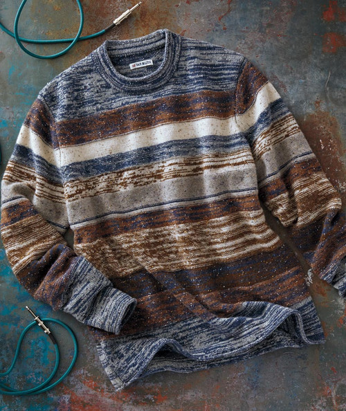 32 Bar Blues Groovy Samba sweater, multicolored striped knit sweater lying on a rustic surface with a teal audio cable with a  plug near it.