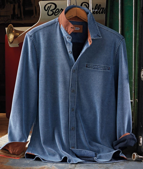 32 Bar Blues Bloozey, stylish men's button-up shirt with a checkered pattern, contrasting brown collar and cuffs, displayed hanging on a wooden hanger against a vintage background.