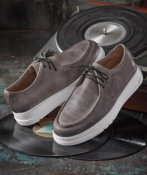 32 Bar Blues Jump Steady Daddy, pair of stylish gray leather sneakers with white soles on vinyl records, with a turntable in the background.