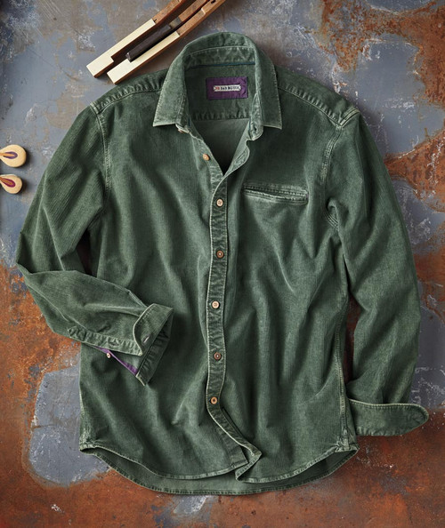 32 Bar Blues Sidekick, green corduroy shirt with button-up front and chest pocket, laid flat on a rustic surface.