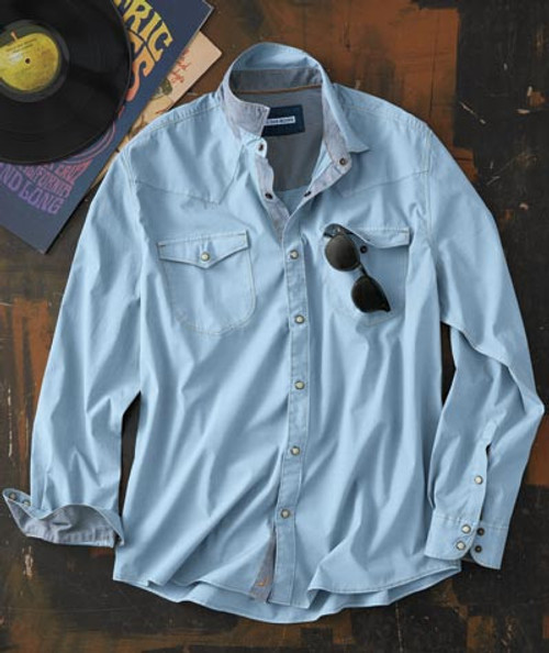32 Bar Blues The Scene Is Clean - Light Blue, a men's light blue button-down shirt with two chest pockets and sunglasses, laid out on a wooden surface with vinyl records and magazines.