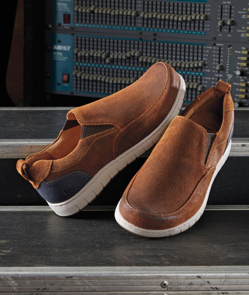 32 Bar Blues Slowly But Surely, pair of brown slip-on sneakers on a dark surface with DJ mixing console in background.