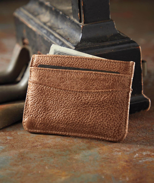 32 Bar Blues A Little This, A Little That, leather wallet with cards and cash, placed on a rustic surface near an antique piano.