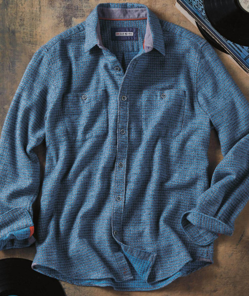 Broken Shadows, blue patterned casual men's shirt with long sleeves and button-up front, laid flat on a wooden surface.