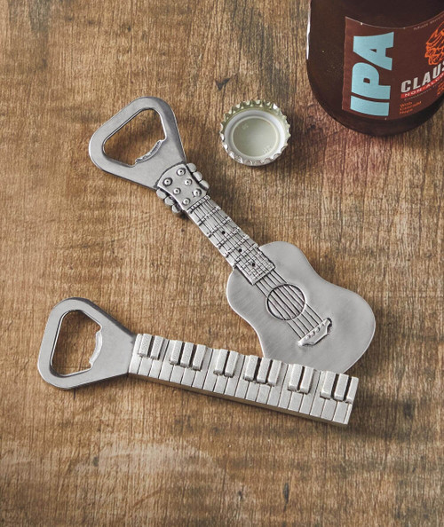 Bottle Rocket - Guitar, creative bottle opener shaped like a guitar with a keyboard-style handle on a wooden surface with a beer bottle and cap.