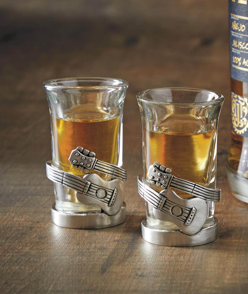 Guitar Slinger, glass holders with guitar-themed metal decor holding glasses of amber-colored liquid.