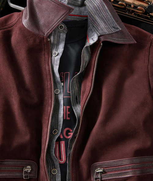 Eight Miles High, close-up of a stylish men's jacket featuring a burgundy leather exterior, a striped inner lining, and zipper details.