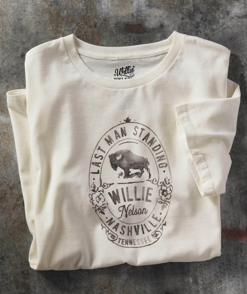 Last Man Standing T-shirt, cream-colored fabric with a vintage-inspired graphic design of a bull and floral accents, featuring the text 'Last Man Standing,' 'Willie Nelson,' and 'Nashville Tennessee'.