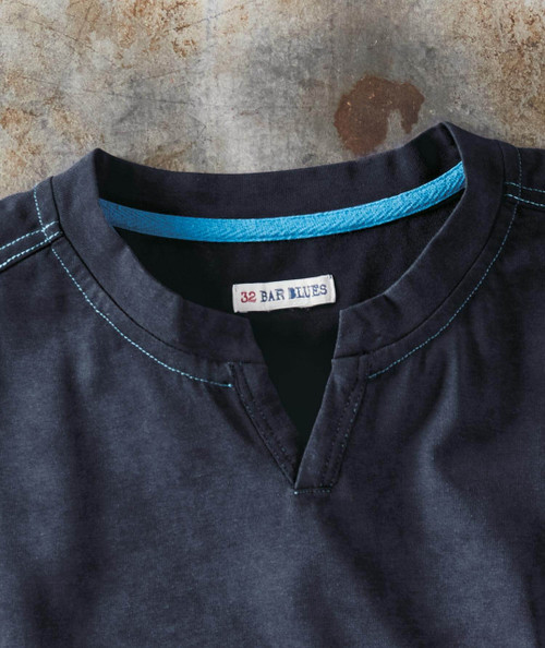 Moody Magic, close-up of a dark blue shirt with a band collar and blue stitching details.