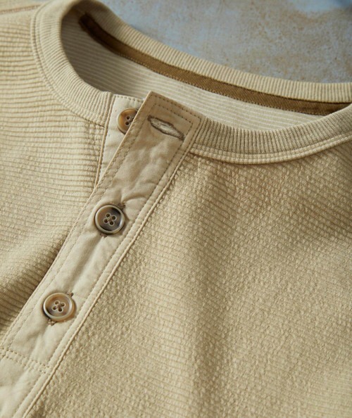 Players Only, close-up of a beige, textured button-up shirt with a collar, beige buttons, and detailed fabric stitching.