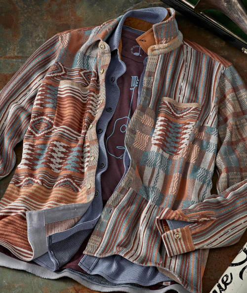 Brilliant Corners, stylish patterned men's button-up shirt with multicolored geometric and striped design, laying on a textured surface.
