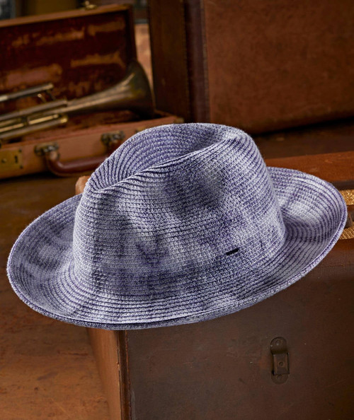 Head Shakin' hat, stylish purple woven fedora hat resting on a wooden surface with vintage musical instruments in the background.