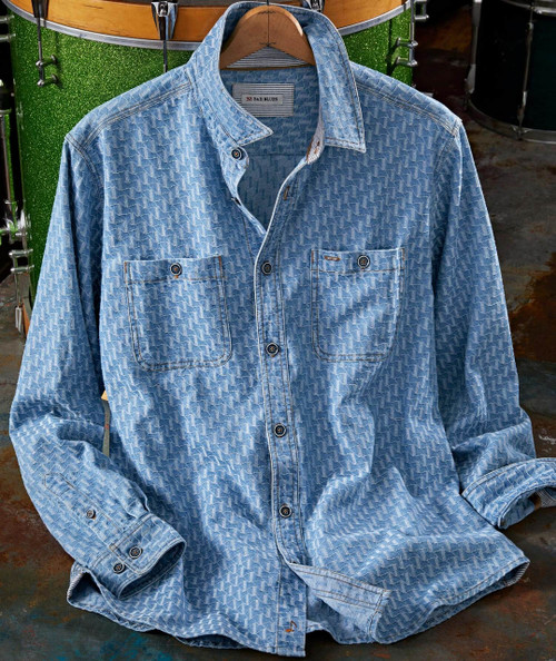 Squiggle Buzz, blue patterned denim shirt with front pockets and button closure.