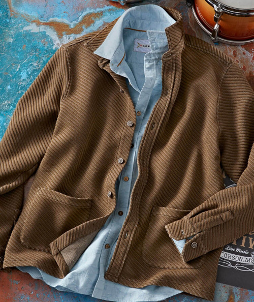 Sweet Rhythm, brown corduroy jacket layered over a light blue shirt on a textured blue and rust background.