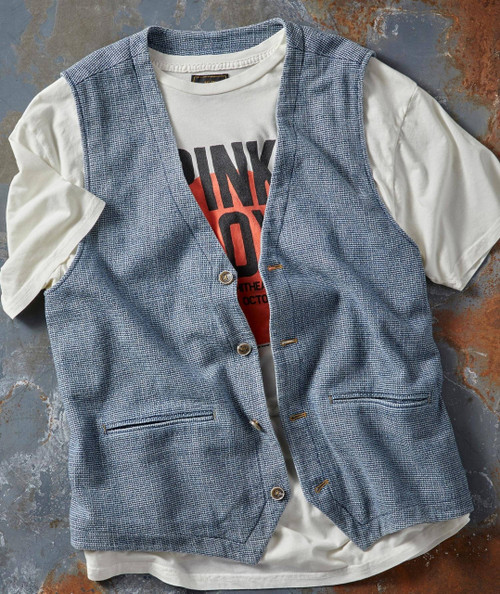 Function At The Junction, stylish men's vest layered over a graphic t-shirt, on a textured surface.