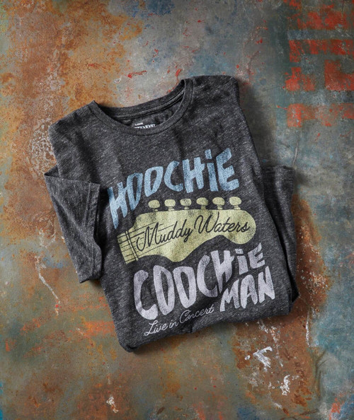Hoochie Coochie Man, black graphic T-shirt featuring a guitar graphic and the text 'Muddy Waters Live in Concert' on a rustic surface.