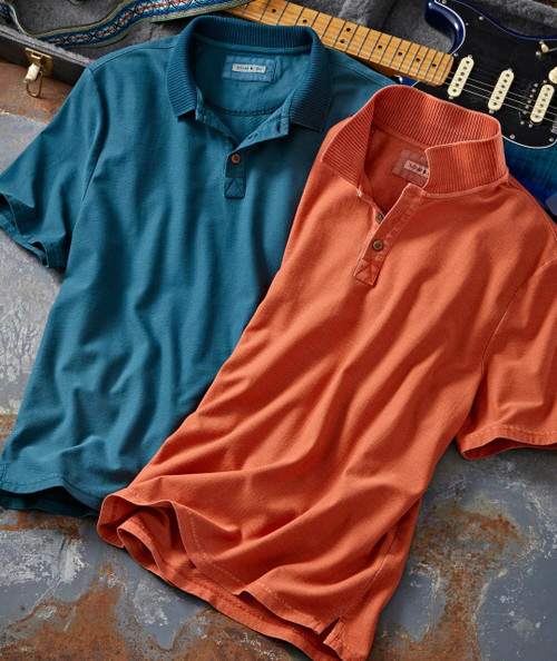 Get A Better One, two colorful polo shirts in teal and rust orange color lying on a textured surface with a guitar in the background.