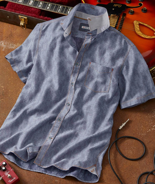 Bye Ya men's short-sleeve button-up shirt, casual light blue dress shirt with subtle zigzag pattern and chest pocket, laid on a surface among musical instruments and guitar accessories.