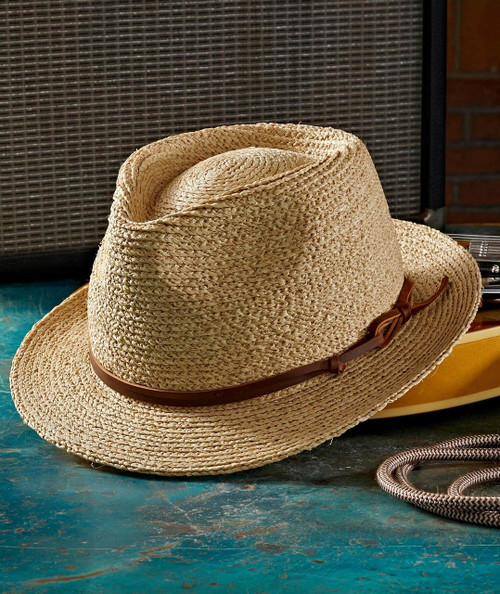 Your Mind Is On Vacation, straw sun hat with brown leather band resting on a textured blue surface with vintage radio in the background.