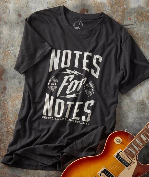Right Start T-shirt, a black graphic T-shirt with white text and design, displayed next to an electric guitar on a textured surface.