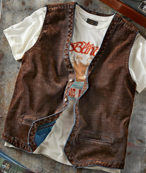Rad Gumbo, vintage brown leather vest over a white vintage band T-shirt with red and blue print.